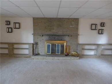 Living Room. Stone log burning fireplace.