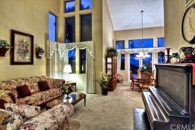 Living and dining areas. A two-story high fireplac