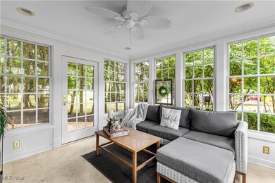 Sunroom with ceiling fan and windows providing tons of sunlight!
