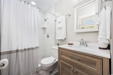 Ensuite primary bathroom with a new tiled shower, 