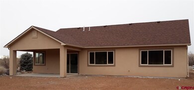 Covered patio overlooking large back yard