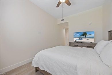 Bedroom with light wood-type flooring, baseboards,