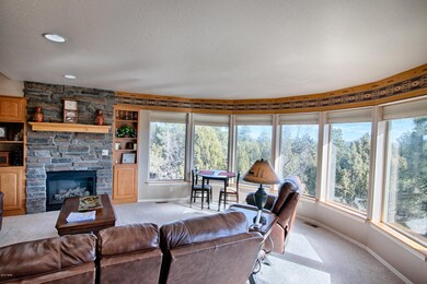 Spacious living area with tree top views