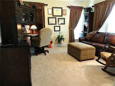 Spacious office / library with plush / carpeting / upgraded pad / ceiling fan and custom window treatments. 