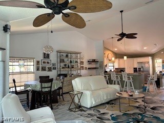 Living room featuring high vaulted ceiling and cei