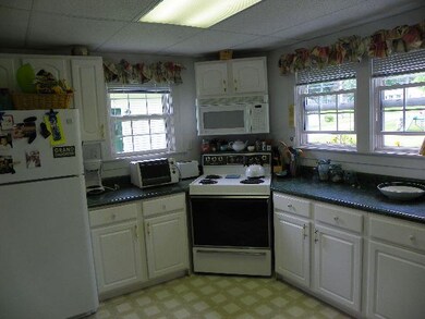 The kitchen has a breakfast bar and opens up to th