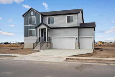 View of front of home with driveway, a garage, board and batten siding, and a shingled roof