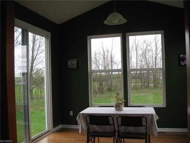 Sun room with hardwood floors and views of private back yard.  Year-round enjoyment!