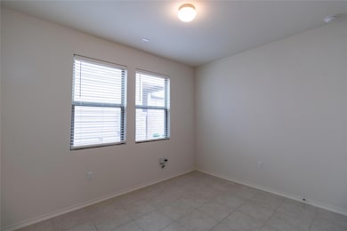 Unfurnished room with baseboards and a smoke dete