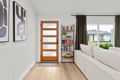 Entryway featuring light wood-style floors and ba