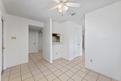 Unfurnished room featuring ceiling fan, light til