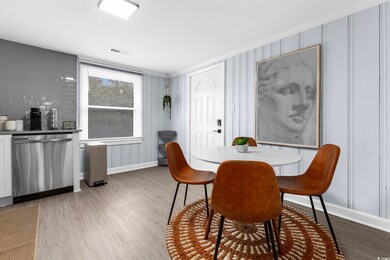 Dining room with ornamental molding and light hard