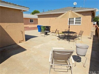 Driveway on left, rear of house at center. This pr