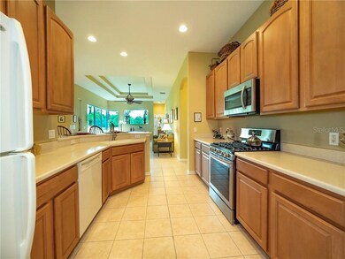 Kitchen: The light wood cabinetry, solid surface c