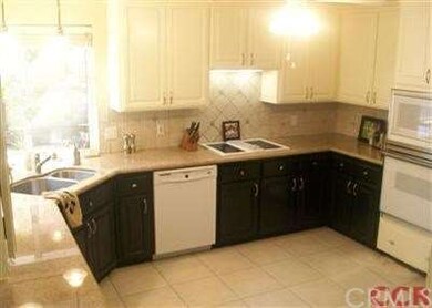 The kitchen features granite counters, is spacious
