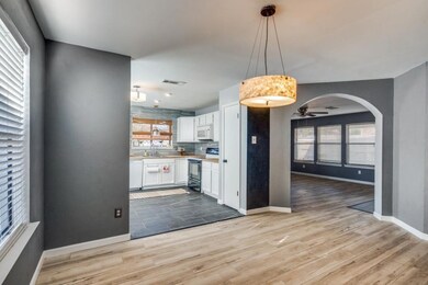 Kitchen featuring white appliances, decorative bac