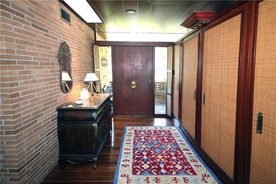 Front foyer lined with coat closets. Beautiful tea