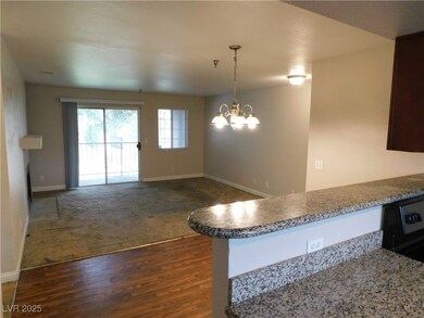 Kitchen with baseboards, an inviting chandelier, a