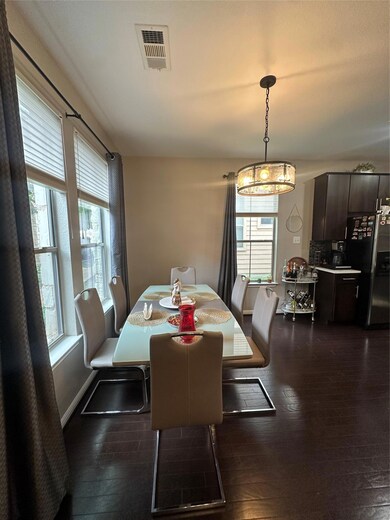 Dining area featuring dark wood-style floors