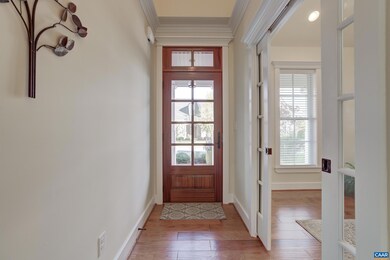 Oversized front door with transom and glass panes.