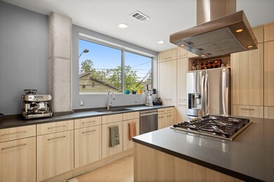 Kitchen with light brown cabinets, exhaust hood, 