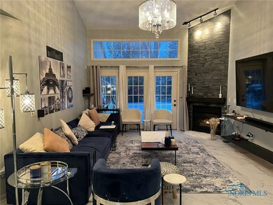 living room with accent wall and fire place