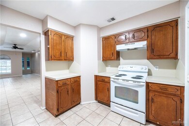 Kitchen with light tile flooring and electric range