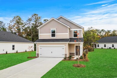 Craftsman-style house featuring a front yard and a