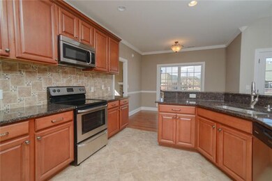 Kitchen with matching Stainless Appliances,   Tile Flooring & Granite Counters. 