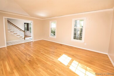 Spare room with ornamental molding, light hardwood