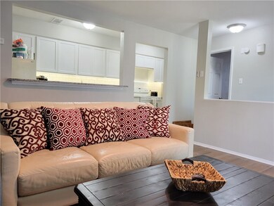 Living room featuring wood finished floors and bas