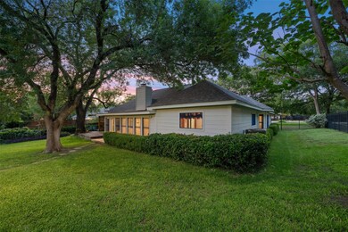 Property exterior at dusk with a fenced backyard,