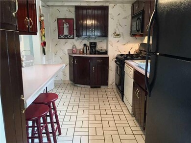 Kitchen. Tile floor, pantry beside breakfast count