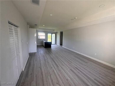 Unfurnished living room featuring dark wood-type f