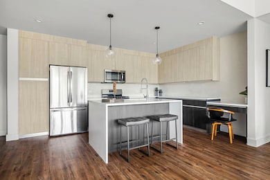 Kitchen featuring stainless steel appliances, lig