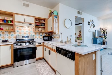 Kitchen featuring open shelves, visible vents, und