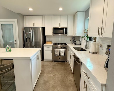 Kitchen featuring appliances with stainless steel