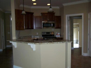 Another view of kitchen counter tops and bar in kitchen.