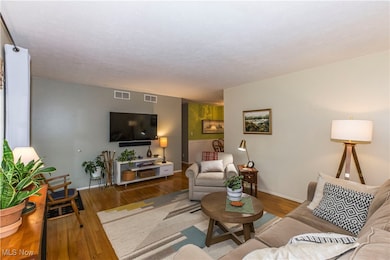 Living room with wood finished floors and baseboards