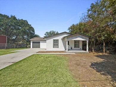 Ranch-style home with a garage and a front lawn