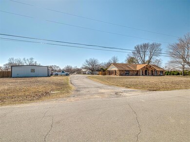 View of front facade featuring aphalt driveway and