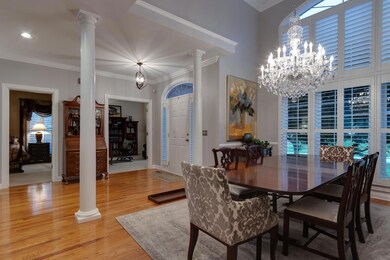 A vaulted ceiling and large windows allow lots of natural light to flow into the dining and living spaces. 