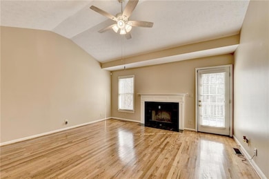 Unfurnished living room featuring a tiled fireplac