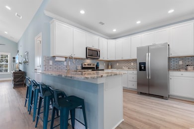 Kitchen featuring light stone countertops, a kitch