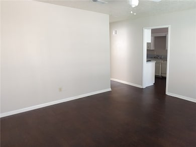 Spare room with a sink, baseboards, dark wood-styl