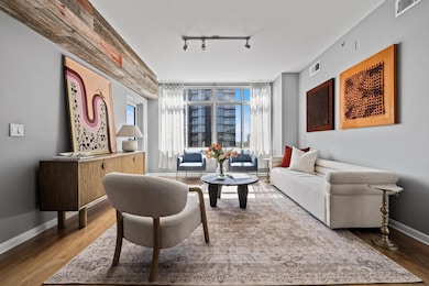 Living room featuring rail lighting, visible vent