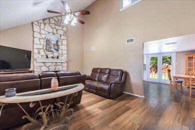 Living area featuring visible vents, hardwood / w