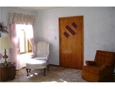 Living Room. Graced with two windows with shutters