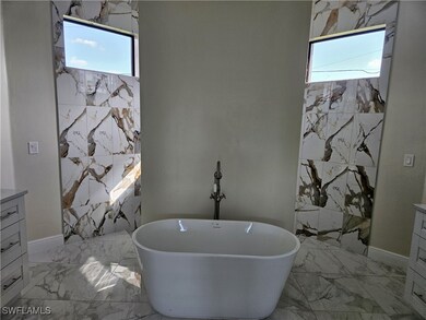 Bathroom featuring marble finish floors, plenty of