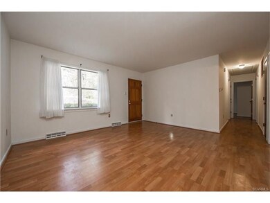 View of living room and hallway with laminate floo